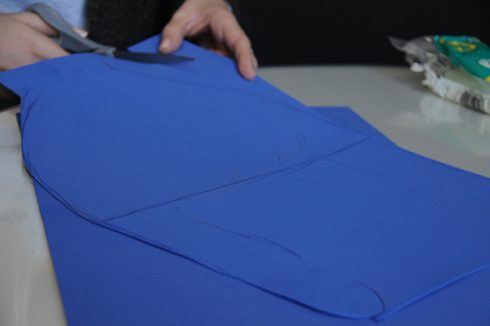 Using the cut out hand as a template to cut the other piece of foam