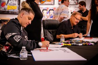 Artists Heather and Charles Fazzino working on art pieces.