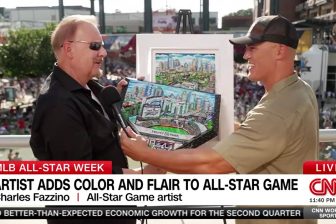 Fazzino holds the 2025 MLB All-Star Game homeplate as he talks to Coy Wire from CNN about it's creation before the ceremonial first pitch