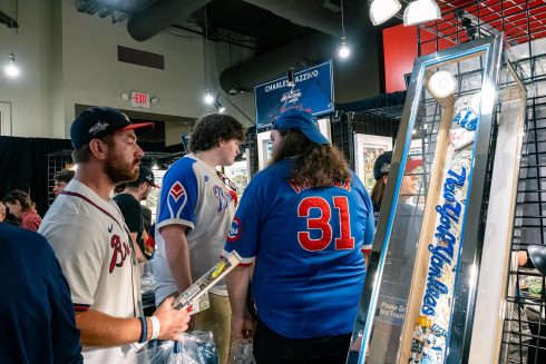 People gather around the Fazzino booth at the All-Star Village