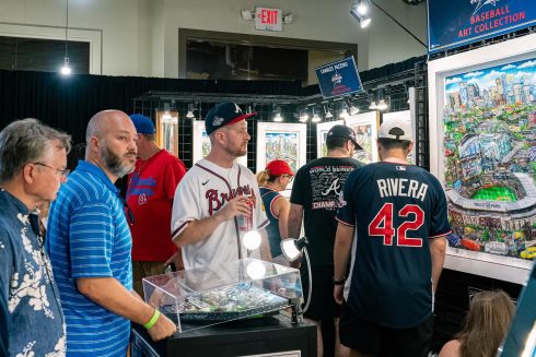 People gather around the Fazzino booth at the All-Star Village