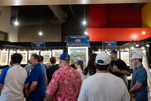 People gather around the Fazzino booth at the All-Star Village
