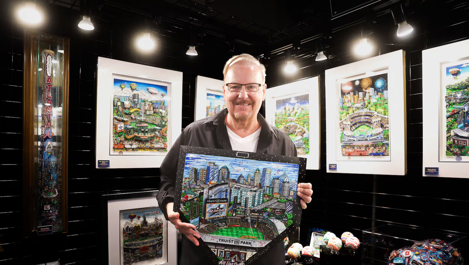 Charles stands in front of the booth of the 2025 MLB All-Star Village holding the homeplate that will be on the field for the ceremonial first pitch