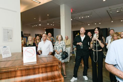 Fazzino in the center of a group of attendees at the VIP event at the Elliot Museum to celebrate the retrospective of his art
